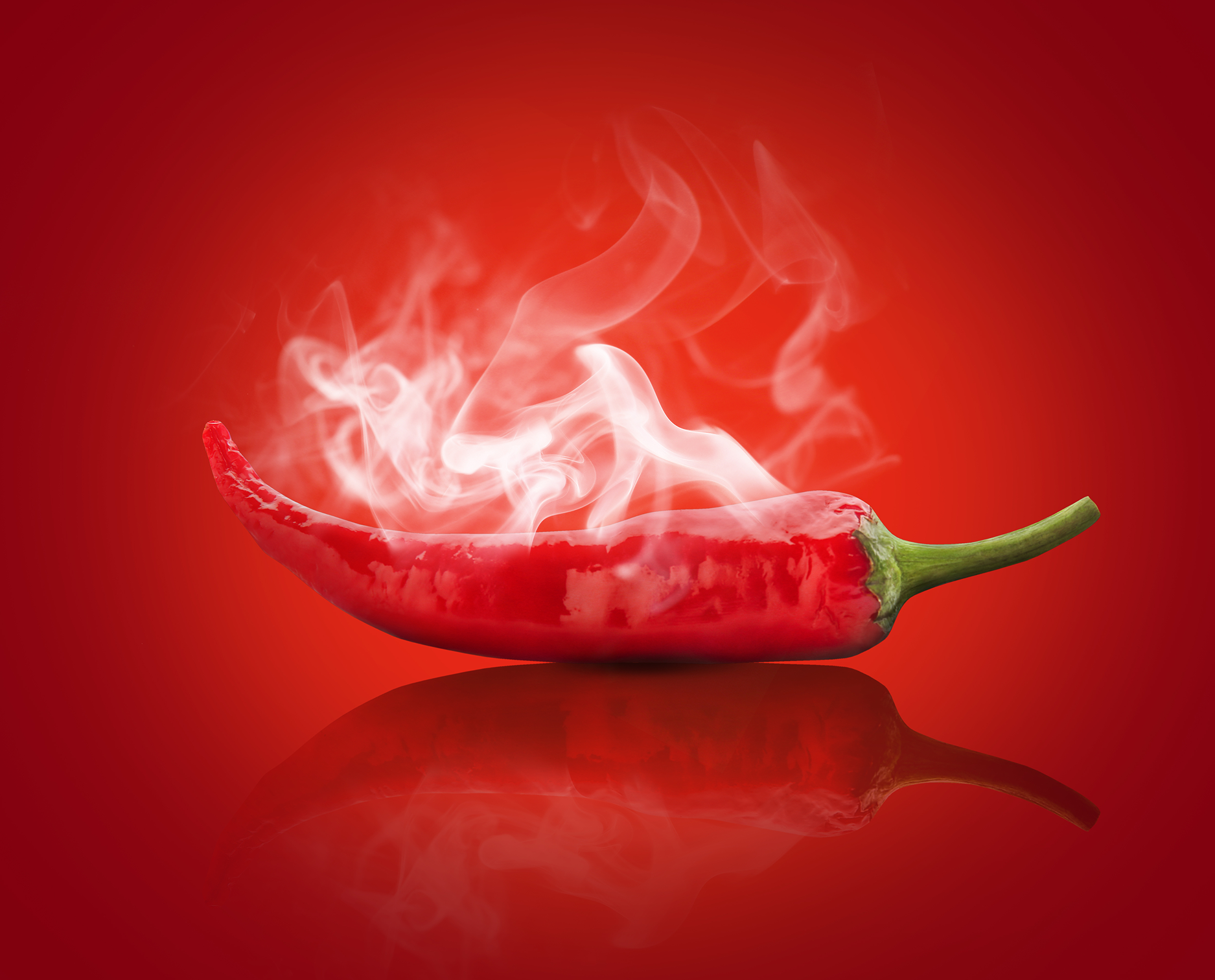 Creative photo manipulation — steaming chili pepper on red